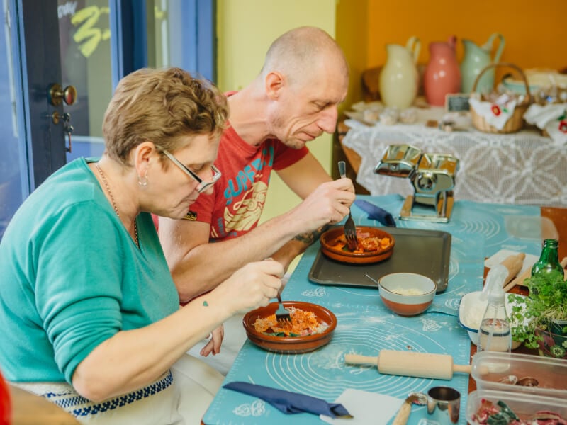 People enjoying handmade pasta together